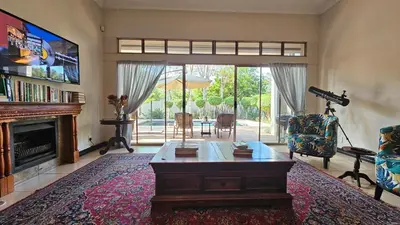a living room with a coffee table and a fireplace at Grobler's Haven in Pretoria