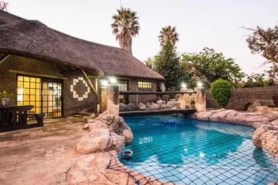 a swimming pool in front of a house at The Guest Villa in Benoni