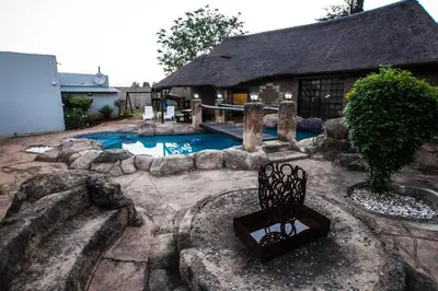 a house with a swimming pool in front of a building at The Guest Villa in Benoni