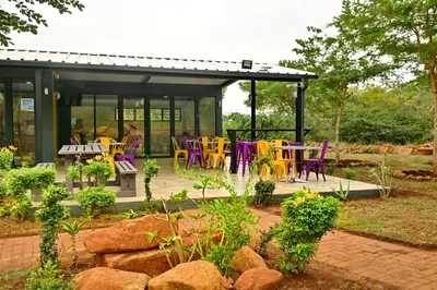 a group of colorful chairs and tables in a garden at SleepOver Punda Maria Gate in Punda Maria