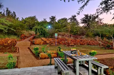a picnic table in the middle of a garden at SleepOver Punda Maria Gate in Punda Maria