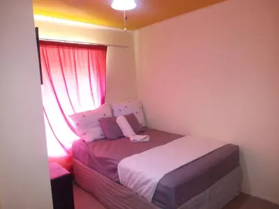 a small bedroom with a bed and a window at Kempton Park Lodge Birch Acres Kempton Park in Kempton Park