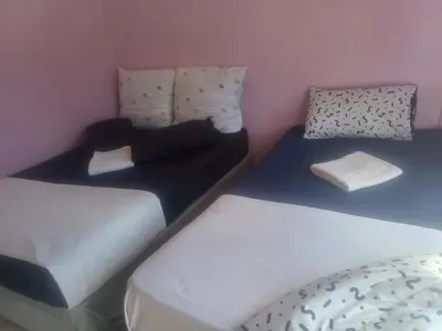 two twin beds in a room with at Kempton Park Lodge Birch Acres Kempton Park in Kempton Park