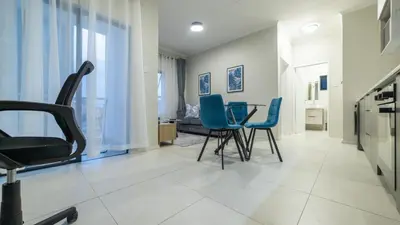 a living room with chairs and a table at Chic Modern Midrand Escape in Midrand