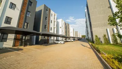 a sidewalk with umbrellas in the middle of a building at Chic Modern Midrand Escape in Midrand