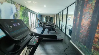 a room with a gym with a treadmill at Chic Modern Midrand Escape in Midrand
