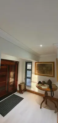 a living room with a table and a window at Luxury GuesthouseCo RiverHouse in Marloth Park