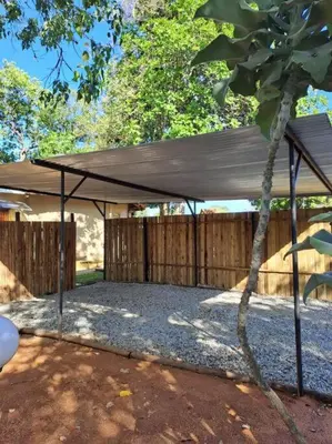 a tent in a yard next to a fence at Wild Fig Accommodation in Tzaneen