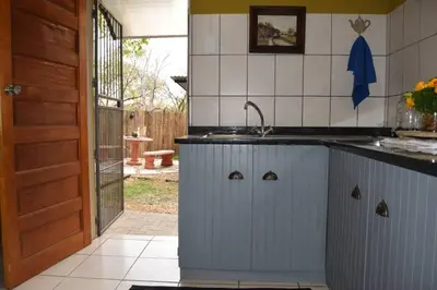 a kitchen with a sink and a counter top at Wild Fig Accommodation in Tzaneen