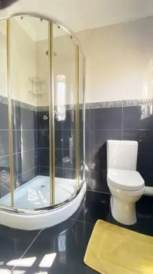 a bathroom with a shower and a toilet at Gorgeous 2-Bedroom apartment in Secunda