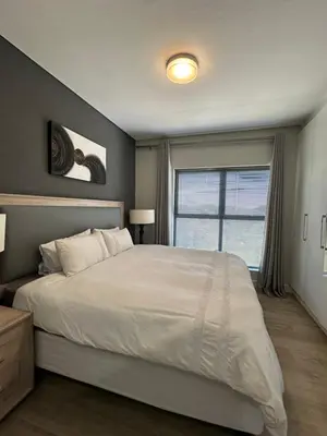 a bedroom with a large bed and a window at House of Grace with Backup power Next to OR Tambo in Kempton Park