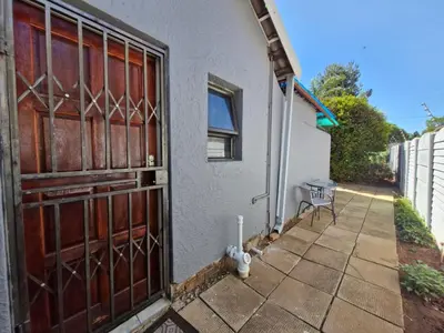 an entrance to a house with a wooden door at Botle Hive in Kempton Park