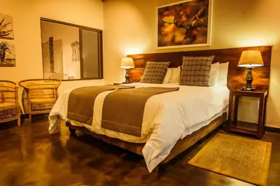 a bedroom with a large bed in a room at Bushveld Terrace Safari Hotel, Lodge & Spa in Phalaborwa