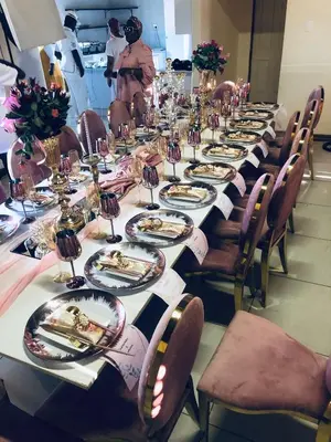 a long table with plates of food on it at In The Bush Farm Lodge in Winterveld