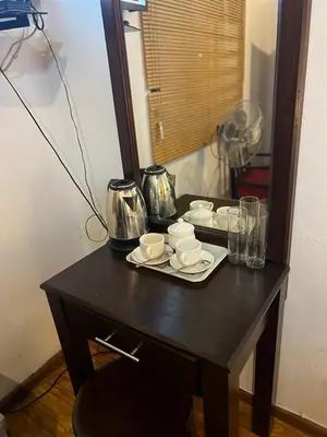 a black table with cups and dishes on it at In The Bush Farm Lodge in Winterveld