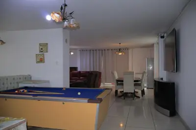 a living room with a pool table and a dining room at Khaya Mnandi Leisure Suites in Pretoria