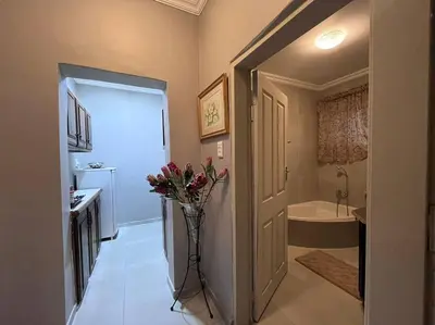 a bathroom with a vase with flowers in it at Hillside Manor in Dalmada AH
