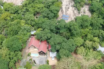 an aerial view of a house in the forest at Serenity Farm House in Karino