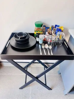 a black table with a plate and utensils on it at TrendyBliss Guest House - n0016 in Northam