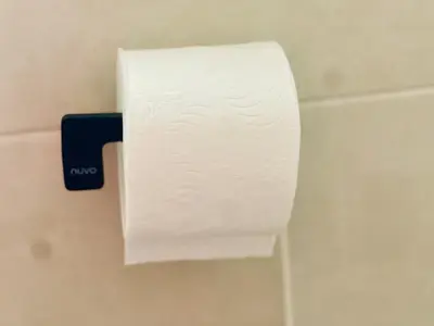 a roll of toilet paper hanging on a wall at TrendyBliss Guest House - n0016 in Northam