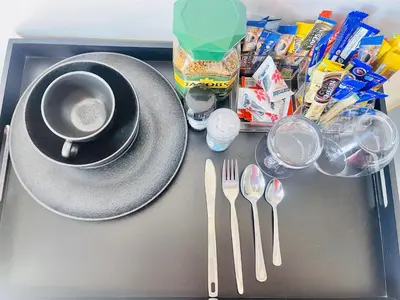 a tray with a plate and a cup and utensils at TrendyBliss Guest House - n0016 in Northam