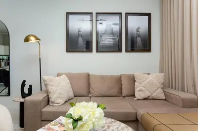 a living room with a couch and four pictures on the wall at Ellipse Waterfall on Magwa cres in Midrand