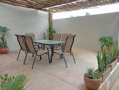 a table and chairs on a patio with plants at Wapadrand Guest Suite in Pretoria