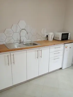 a kitchen counter with a sink and a microwave at Wapadrand Guest Suite in Pretoria