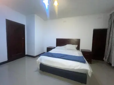 a bedroom with a large bed in a room at Khaya Mnandi Leisure Suites in Pretoria