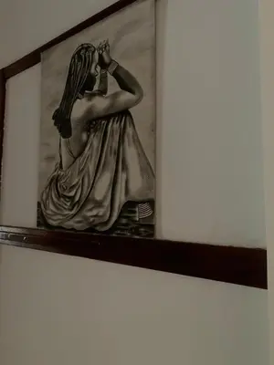 a painting of a woman in a dress on a wall at Khaya Mnandi Leisure Suites in Pretoria