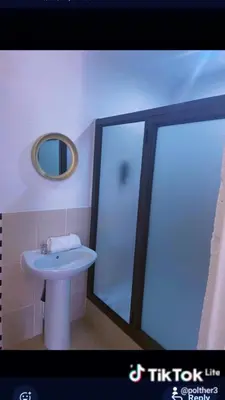 a bathroom with a white sink and a mirror at Riverside guesthouse in Phalaborwa