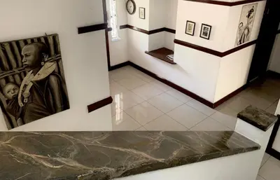 a museum with a picture of a statue on a wall at Khaya Mnandi Leisure Suites in Pretoria