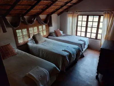 a bedroom with three beds and two windows at Tumuga Private Cottage Mokopane in Amatava