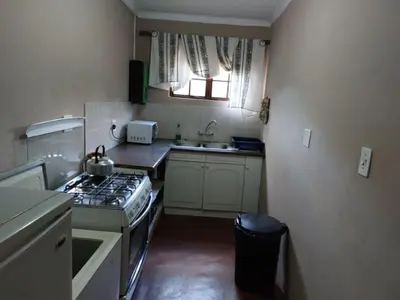 a small kitchen with a stove and a sink at Tumuga Private Cottage Mokopane in Amatava