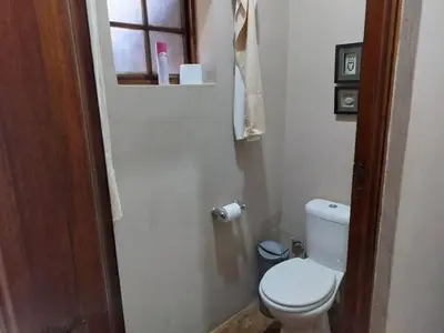 a small bathroom with a toilet and a window at Tumuga Private Cottage Mokopane in Amatava