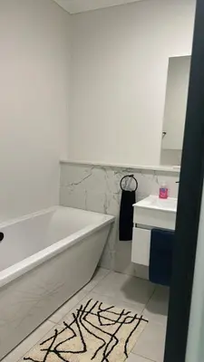 a bathroom with a tub and a sink and a mirror at The Blyde Crystal Lagoon Luxury Stays in Pretoria