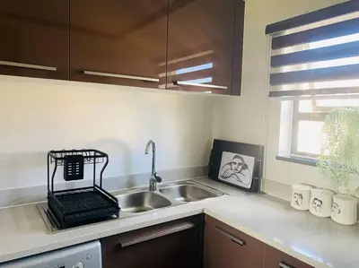 a kitchen counter with a sink and a window at LuxuryHome in Midrand