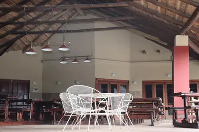 a table and chairs in a room with lights at Umnotho We Afrika House in Erasmus
