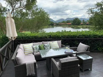 a patio with a couch and a table and an umbrella at Modern 5BR Villa - Golf Course - Pecanwood Estate in Hartbeespoort