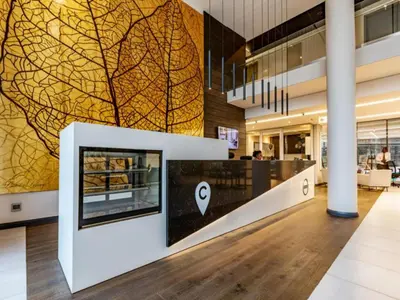 a lobby with a wall with a picture of a tree on it at Menlyn Maine Luxury Apartments - Penthouse 1217 in Pretoria