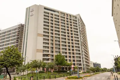 a tall white building on a city street at Menlyn Maine Luxury Apartments - Penthouse 1217 in Pretoria