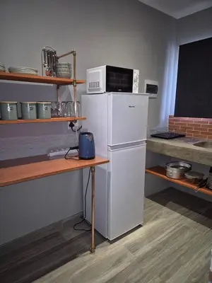 a kitchen with a microwave on top of a refrigerator at @241 Enkeldoorn Guesthouse in Pretoria