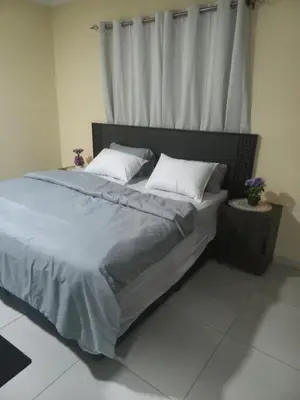 a bedroom with a large bed with a window at First derby Lodge in Benoni