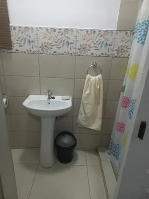 a small bathroom with a sink and a towel at First derby Lodge in Benoni