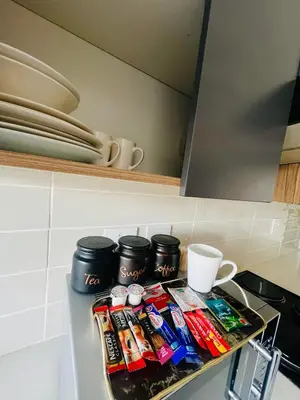 a tray of food on a kitchen counter with a cup at Greencreek Riverwalk in Pretoria