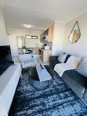 a living room with a couch and a coffee table at Greencreek Riverwalk in Pretoria