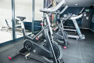 a row of exercise bikes in a gym at The Ellipse Palazzo Apartment in Midrand