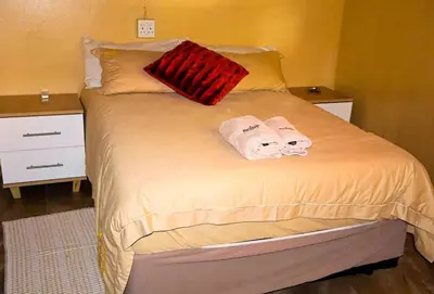 a bedroom with a bed with towels on it at Africa Self Catering Chalets - Manyeleti in Manyeleti Game Reserve