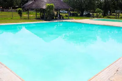 a large swimming pool with blue water at Africa Self Catering Chalets - Manyeleti in Manyeleti Game Reserve