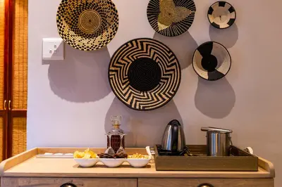 a counter with plates on the wall and a tray of food at Inyati Game Lodge in Sabi Sand Game Reserve